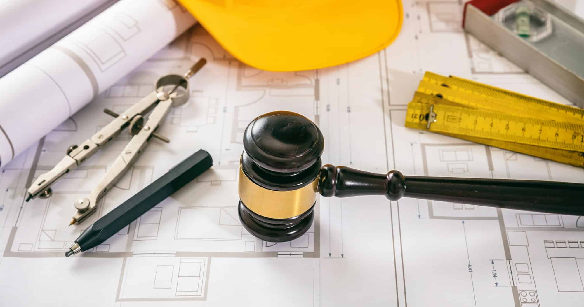 Construction and Labor law. Judge gavel and design tools on building blueprint